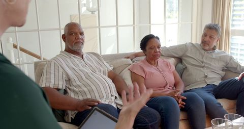 Senior Friends Enjoying Lively Conversation at Home