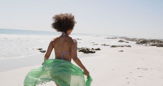 Woman Enjoying Sunny Day on Beach with Green Sarong - Download Free Stock Images Pikwizard.com