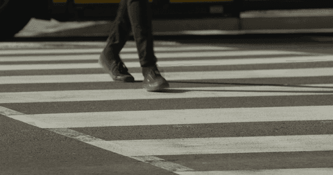 person crossing zebra marked transparent crosswalk in urban area - Download Free Stock Videos Pikwizard.com