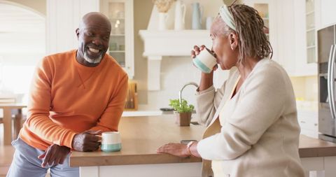 Happy Senior Couple Enjoying Coffee in Bright Kitchen