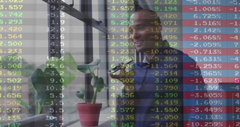 Businessman Contemplating Work in Modern Office with Stock Market Data Overlay