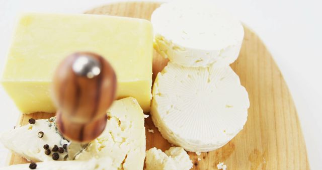 Assorted Cheeses on Wooden Board with Cheese Slicing Tool - Download Free Stock Images Pikwizard.com