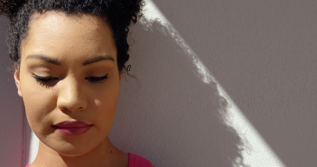 Young Woman with Curly Hair in Thoughtful Moment - Download Free Stock Images Pikwizard.com