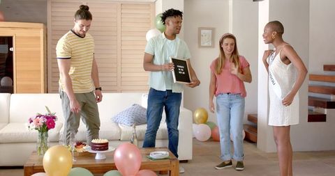 Friends celebrating birthday with decorations and balloons