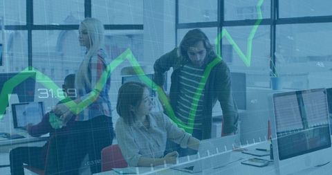 Team collaborating around laptop with green growth chart overlay in modern coworking space