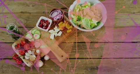 Overhead rustic salad ingredients on wooden table with magenta network overlay, flat lay