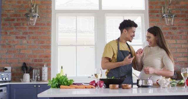 Happy Couple Cooking Together in Modern Kitchen with Brick Wall - Download Free Stock Images Pikwizard.com