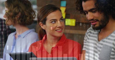 Young Analysts Engaged in Teamwork with Stock Graph Overlay