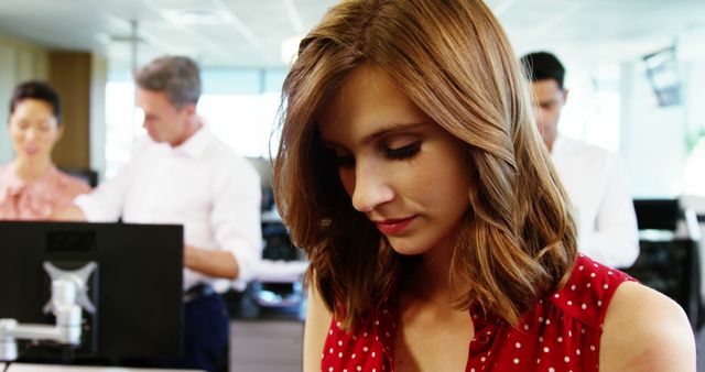 Focused Businesswoman in Red Polka Dot Dress in Modern Office - Download Free Stock Images Pikwizard.com