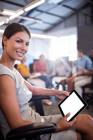 Smiling Businesswoman Holding Transparent Digital Tablet in Office Setting