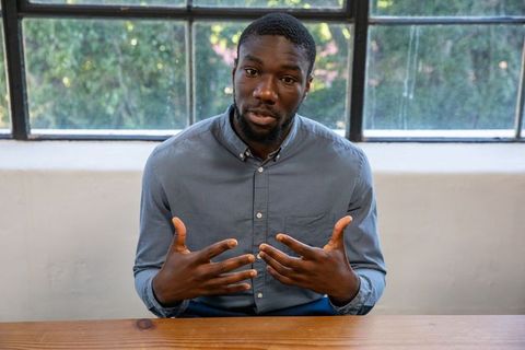 Confident man communicating ideas in bright office space