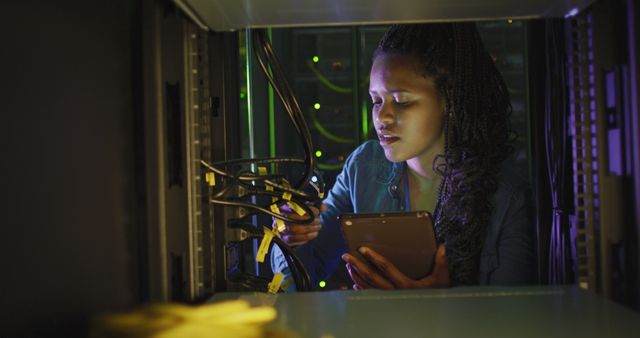African American Woman Working on Network Server Equipment in Data Center - Download Free Stock Photos Pikwizard.com