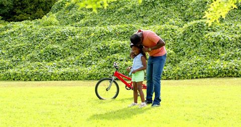 Father and Daughter Outdoor Cycling Preparation in Nature Park