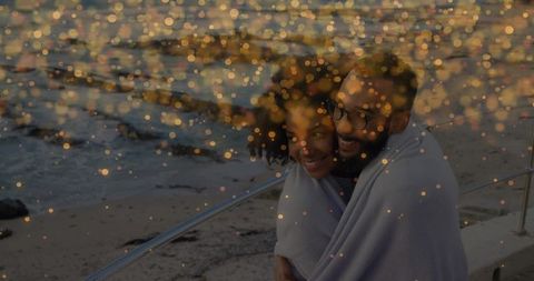 Couple Embracing by Seaside at Dusk with Bokeh Effect