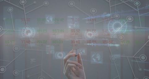 Hand holding bulb amidst futuristic data display