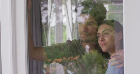 Thoughtful Multiracial Couple Gazing through Window Together - Download Free Stock Images Pikwizard.com