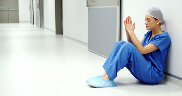 Tired Healthcare Professional Resting in Hospital Corridor - Download Free Stock Images Pikwizard.com