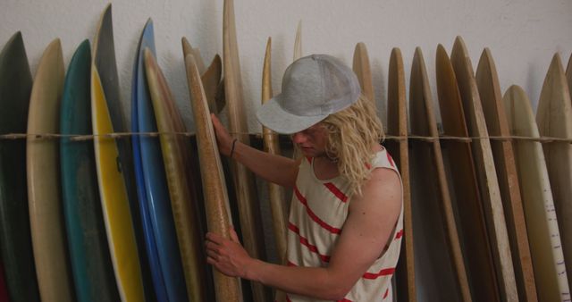 Male Surfer Choosing Surfboard in Surf Shop - Download Free Stock Images Pikwizard.com