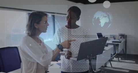 Colleagues collaborating over laptop with futuristic digital interface