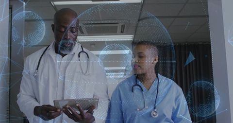 Medical Team Reviewing Tablet with Augmented Reality Data in Hospital Corridor