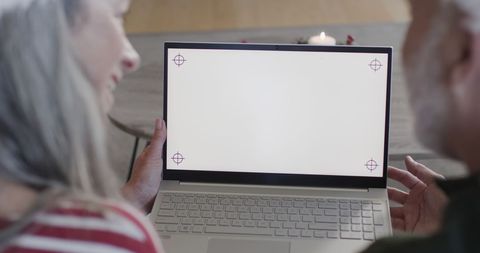 Middle Aged Couple Enjoying Christmas Time with Blank Laptop Screen - Download Free Stock Images Pikwizard.com