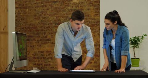 Focused Teamwork Young Professionals Using Digital Tablet