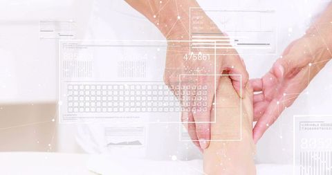 Therapist holding and pressing foot with digital hud overlay for smart podiatry care