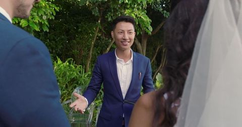 Wedding ceremony with bride and groom outdoors exchanging vows