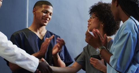 Healthcare Team Applauding in Hospital Corridor Celebration