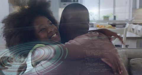 Father and daughter embracing on couch with futuristic hud and code overlay for family tech concept