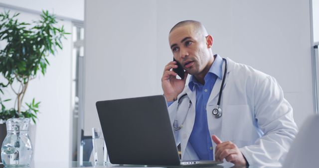 Caucasian Male Doctor Talking on Phone in Office - Download Free Stock Images Pikwizard.com