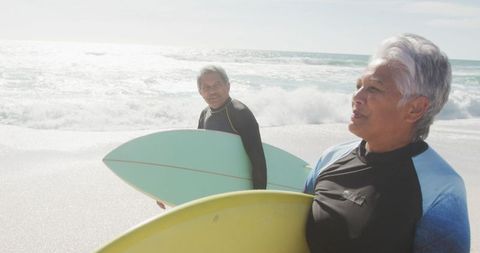 Elderly Couple Enjoying Surfing on Sunny Beach