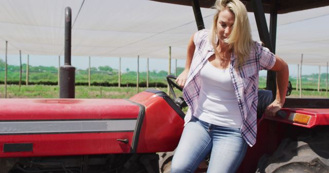 Female Farmer Getting Off Tractor in Field - Download Free Stock Images Pikwizard.com