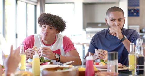 Diverse friends enjoying burgers at lunch gathering