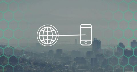 Global to mobile connectivity concept overlaying hazy coastal cityscape with teal hex grid