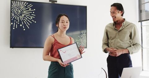 Colleagues celebrating achievement in modern office