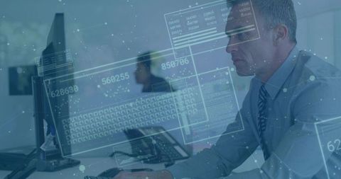 Mature professional typing at desk with cybersecurity hud overlay, analytics workspace