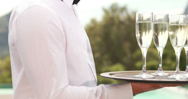 Waiter Serving Champagne at Outdoor Celebratory Event - Download Free Stock Images Pikwizard.com