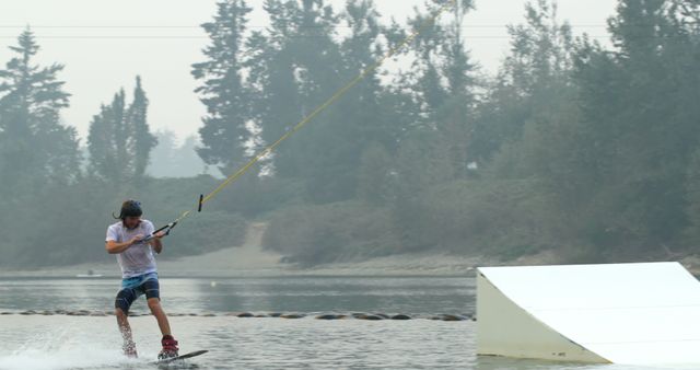 Young Man Wakeboarding on Lake in Foggy Weather - Download Free Stock Images Pikwizard.com