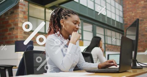 Confident Businesswoman Analyzing Data with Laptop in Modern Office