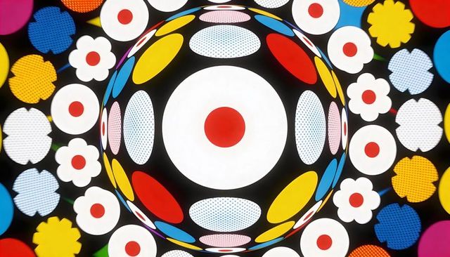 Kaleidoscopic luminous orb with red-centered disc, colorful floral dots and geometric leds