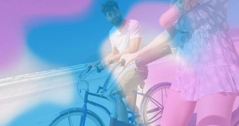Couple cycling on sunlit beach with pastel overlay, retro cruiser bikes and casual summer style