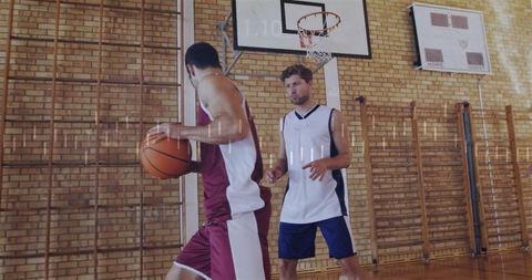 Two men playing intense basketball game in indoor gym