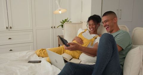 Relaxed Couple Enjoys Laptop Entertainment at Home