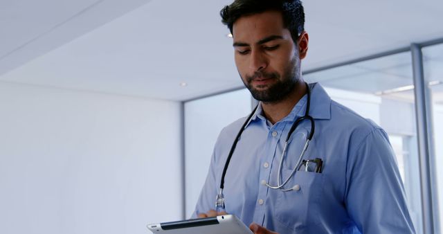Male doctor using digital tablet at the hospital