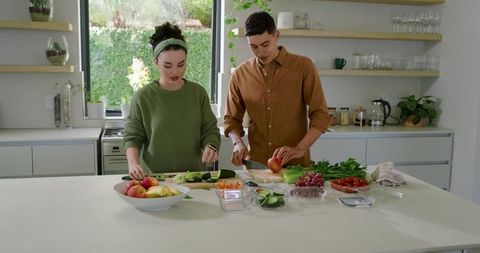 Couple Preparing Fresh Produce in Modern Kitchen