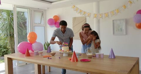 Family Celebrating Birthday with Joyful Cake Decoration at Home