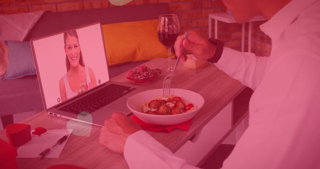 Multiple heart icons floating over caucasian man having lunch while having a image call on laptop. distant celebration of valentines day online and dating concept