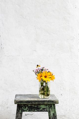 Rustic Setting with Bright Yellow Blossoms in a Glass Jar