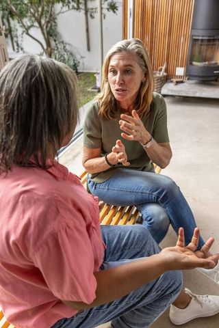 Two Women Engaging in Conversation at Modern Home Lounge